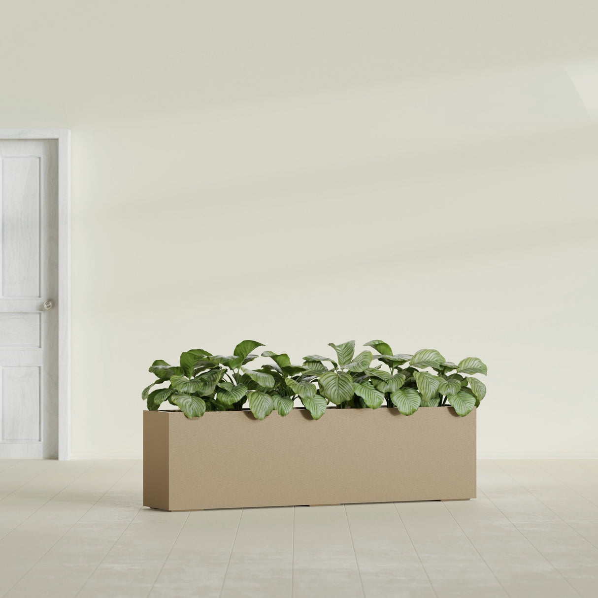 Hudson Extra Long fiberglass planter in Gloss Metallic Gold, shown planted, in a sunlit interior