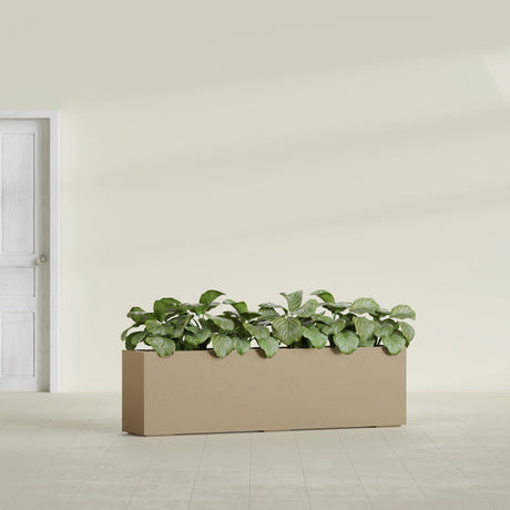 Hudson Extra Long fiberglass planter in Gloss Metallic Gold, shown planted, in a sunlit interior
