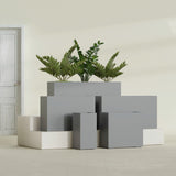 Potsdam Corner fiberglass planter in Matte Gunmetal, size range, in a sunlit interior