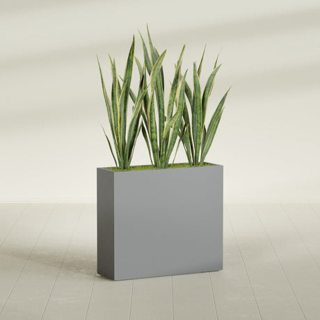 Delray Corner fiberglass planter in Matte Gunmetal, shown planted, in a sunlit interior