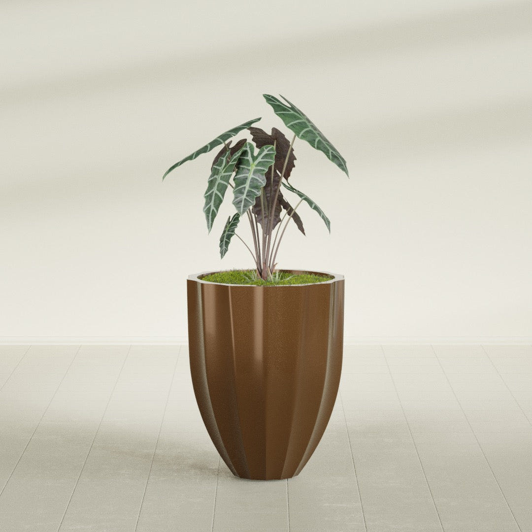Alicante Fluted fiberglass planter in Metallic Bronze, shown planted, in a sunlit interior