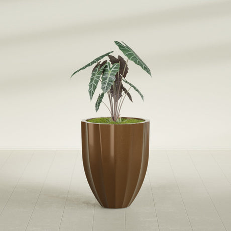 Alicante Fluted fiberglass planter in Metallic Bronze, shown planted, in a sunlit interior