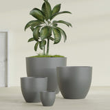 Wannsee Round fiberglass planter in Matte Gunmetal, size range, in a sunlit interior