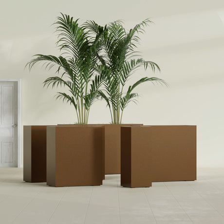 Perth Corner fiberglass planter in Metallic Bronze, size range, in a sunlit interior