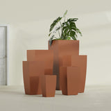 Toulan Tapered Square fiberglass planter in Matte Terra Cotta, size range, in a sunlit interior