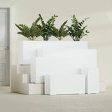 Hollywood Corner fiberglass planter in Gloss Bright White, size range, in a sunlit interior