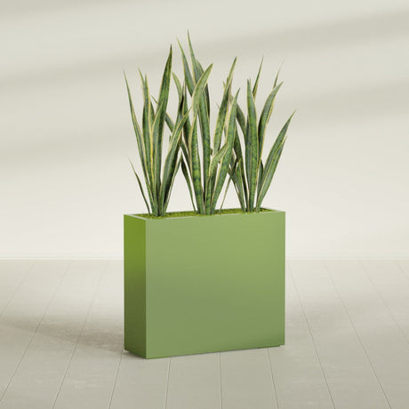 Delray Corner fiberglass planter in Satin Green, shown planted, in a sunlit interior