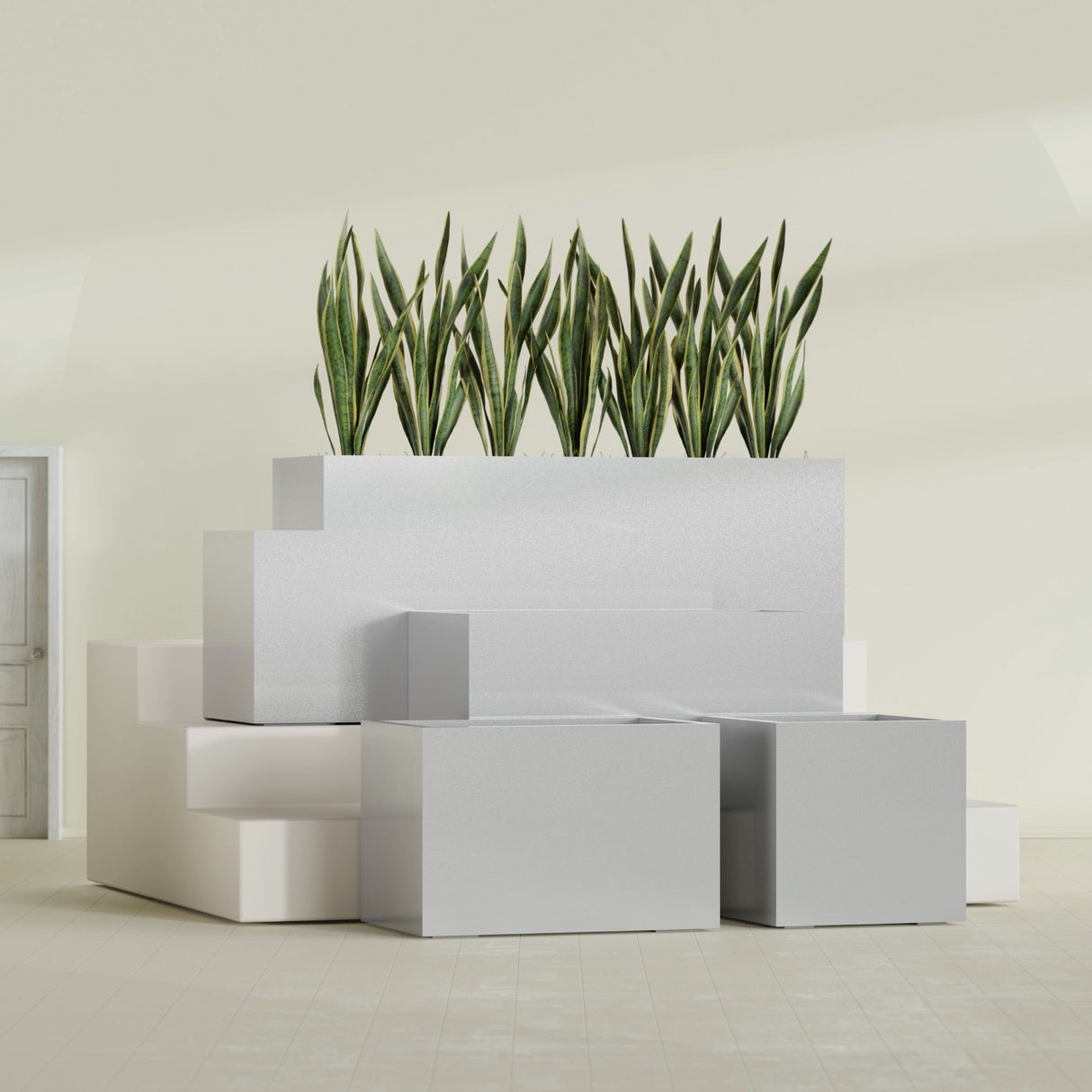 Granada fiberglass planter in Metallic Silver, size range, in a sunlit interior