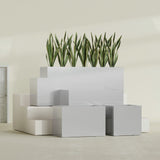 Granada fiberglass planter in Metallic Silver, size range, in a sunlit interior