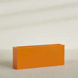 Hollywood Narrow Rectangular Planter in Gloss Tangerine, 60"L × 12"D × 24"H, shown empty