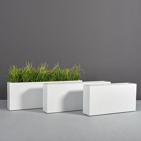 Camoux narrow rectangular fiberglass planter, three sizes shown together, the smallest planted with ornamental grass