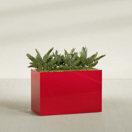 Brisbane Rectangular fiberglass planter in Gloss Red, shown planted, in a sunlit interior