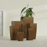 Toulan Tapered Square fiberglass planter in Metallic Bronze, size range, in a sunlit interior