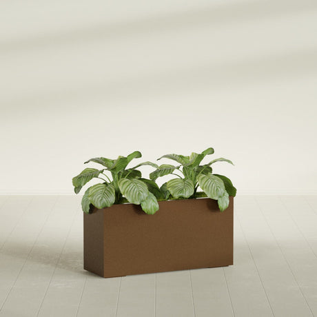 Miami Corner fiberglass planter in Metallic Bronze, shown planted, in a sunlit interior