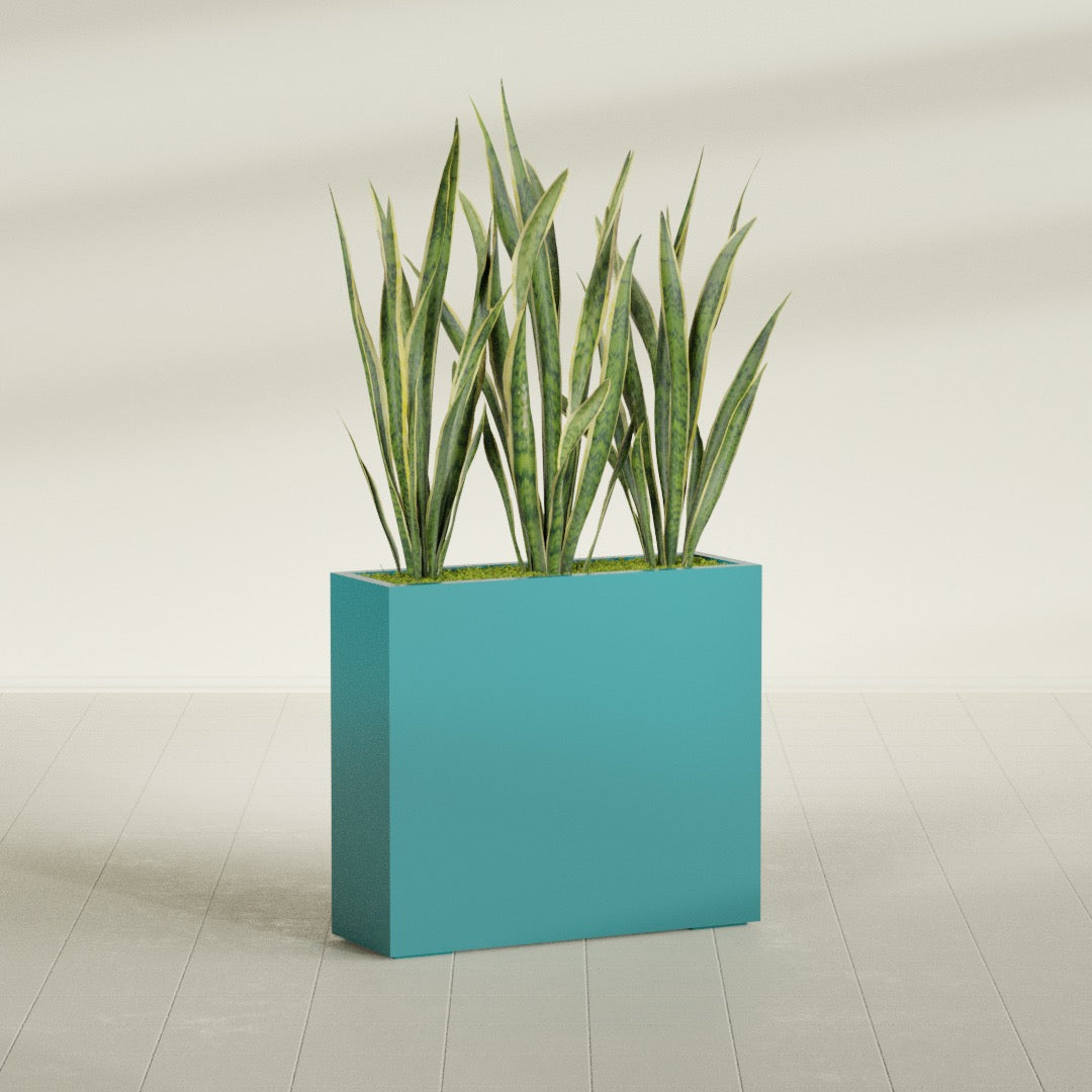 Delray Corner fiberglass planter in Satin Seafoam Green, shown planted, in a sunlit interior