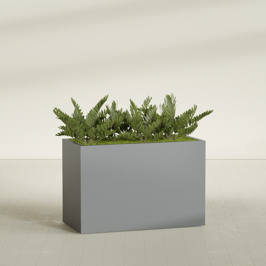 Brisbane Rectangular fiberglass planter in Matte Gunmetal, shown planted, in a sunlit interior