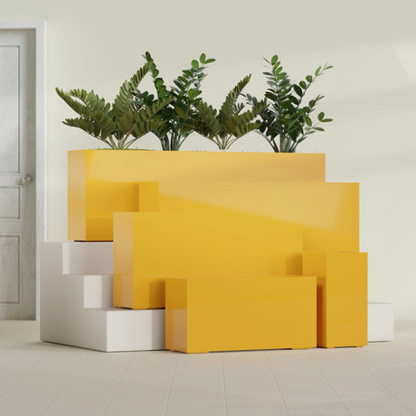 Hollywood Corner fiberglass planter in Gloss Saffron, size range, in a sunlit interior