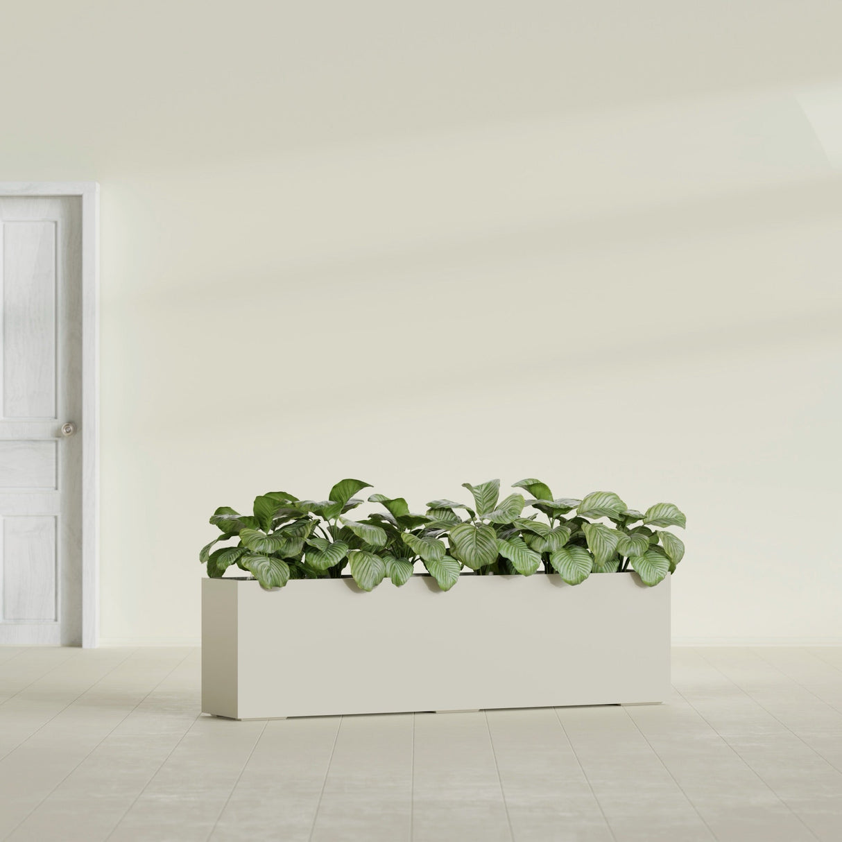 Hudson Extra Long fiberglass planter in Satin Beige, shown planted, in a sunlit interior