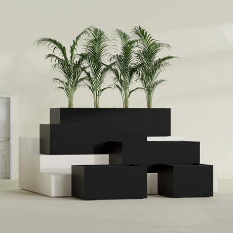 Torino Corner fiberglass planter in Matte Black, size range, in a sunlit interior