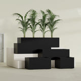 Torino Wide Rectangular fiberglass planter in Matte Black, size range, in a sunlit interior
