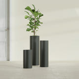 Corry Cylinder fiberglass planter in Matte Charcoal, size range, in a sunlit interior