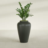 Barà Jar fiberglass planter in Matte Charcoal, shown planted, in a sunlit interior