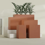 Darwin Corner fiberglass planter in Matte Terra Cotta, size range, in a sunlit interior
