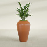 Barà Jar fiberglass planter in Matte Terra Cotta, shown planted, in a sunlit interior