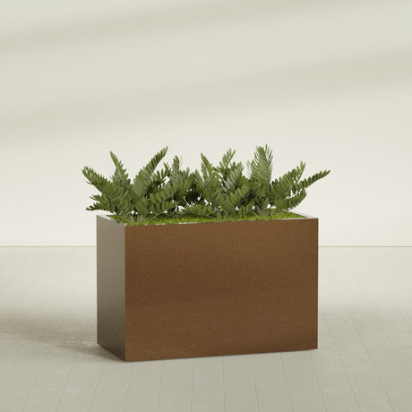Brisbane Rectangular fiberglass planter in Metallic Bronze, shown planted, in a sunlit interior