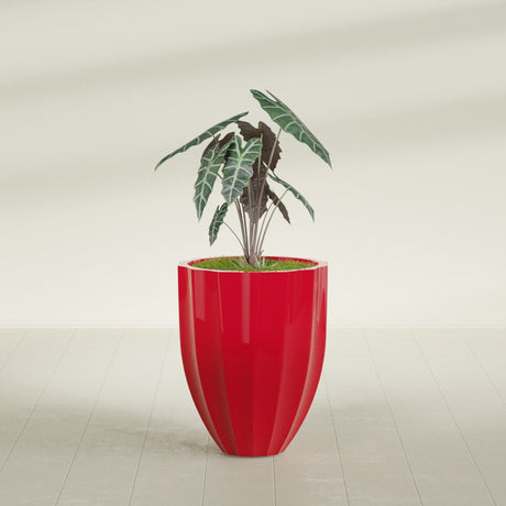Alicante Fluted fiberglass planter in Gloss Red, planted, in a sunlit interior
