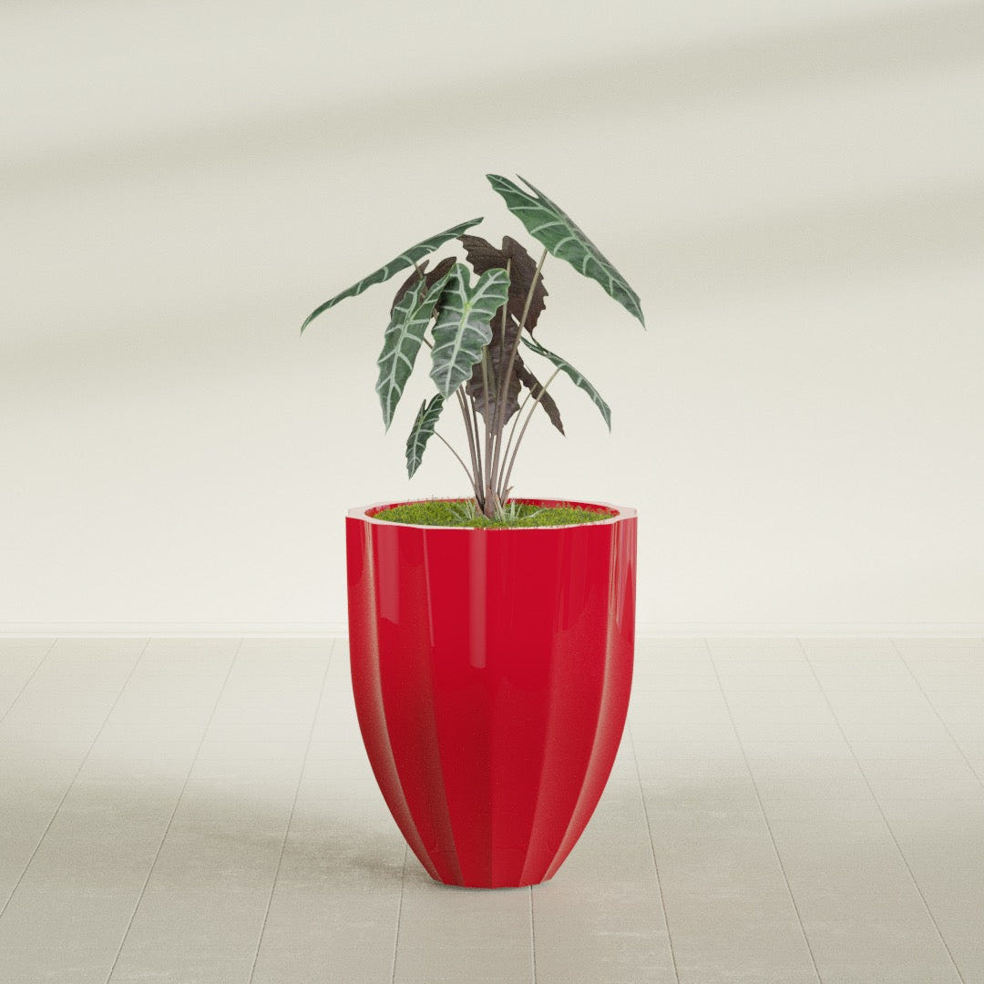 Alicante Fluted fiberglass planter in Gloss Red, shown planted, in a sunlit interior