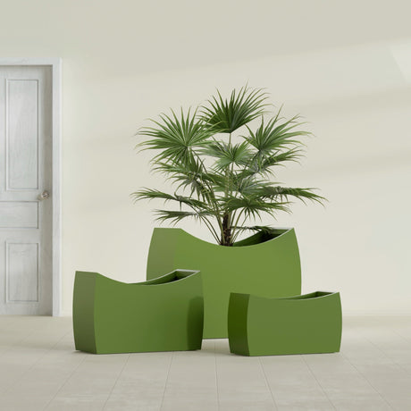 Seoul Curved fiberglass planter in Satin Green, size range, in a sunlit interior