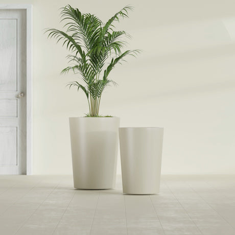 Tegel Round Tapered fiberglass planter in Satin Beige, size range, in a sunlit interior