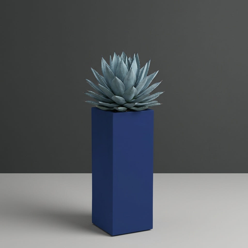 Delray Corner fiberglass planter in Matte Cobalt Blue, planted with blue-grey agave, studio