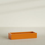 Antwerp Rectangular Planter in Gloss Tangerine, 60"L × 24"D × 12"H, shown empty