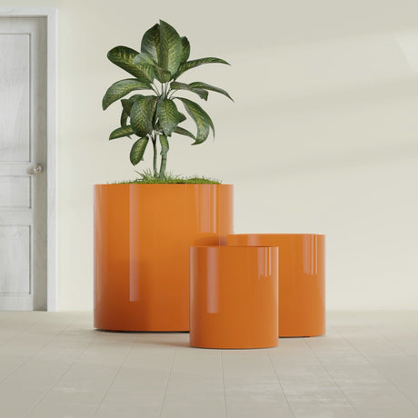 Rio Grande Cylinder fiberglass planter in Gloss Tangerine, size range, in a sunlit interior