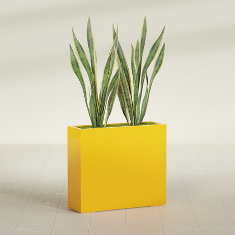 Perth Corner fiberglass planter in Gloss Saffron, shown planted, in a sunlit interior