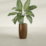 Lisbon Tall Round fiberglass planter in Metallic Bronze, shown planted, in a sunlit interior