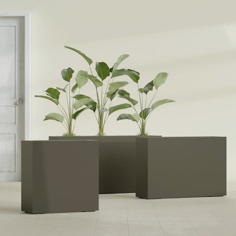Milano Narrow Rectangular fiberglass planter in Matte Bronze, shown planted, in a sunlit interior