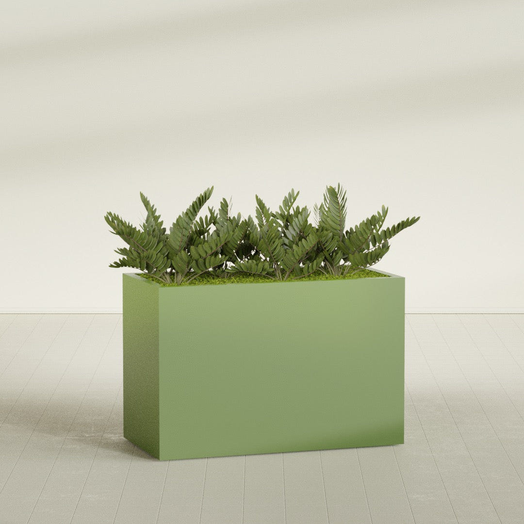 Brisbane Rectangular fiberglass planter in Satin Green, shown planted, in a sunlit interior