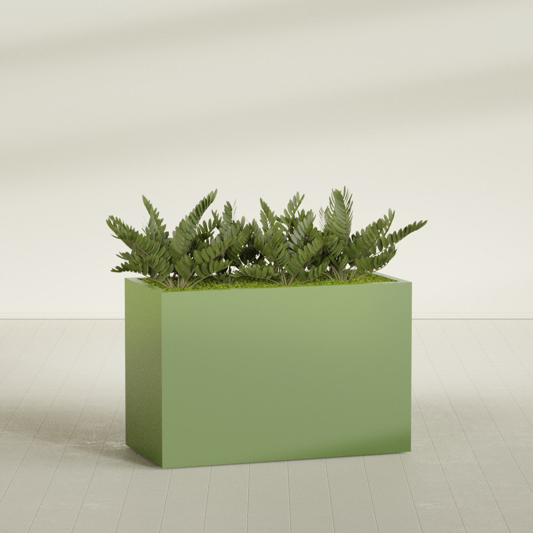 Brisbane Rectangular fiberglass planter in Satin Green, shown planted, in a sunlit interior