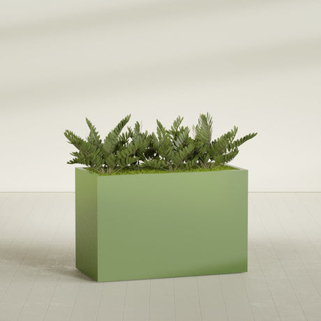 Brisbane Rectangular fiberglass planter in Satin Green, shown planted, in a sunlit interior