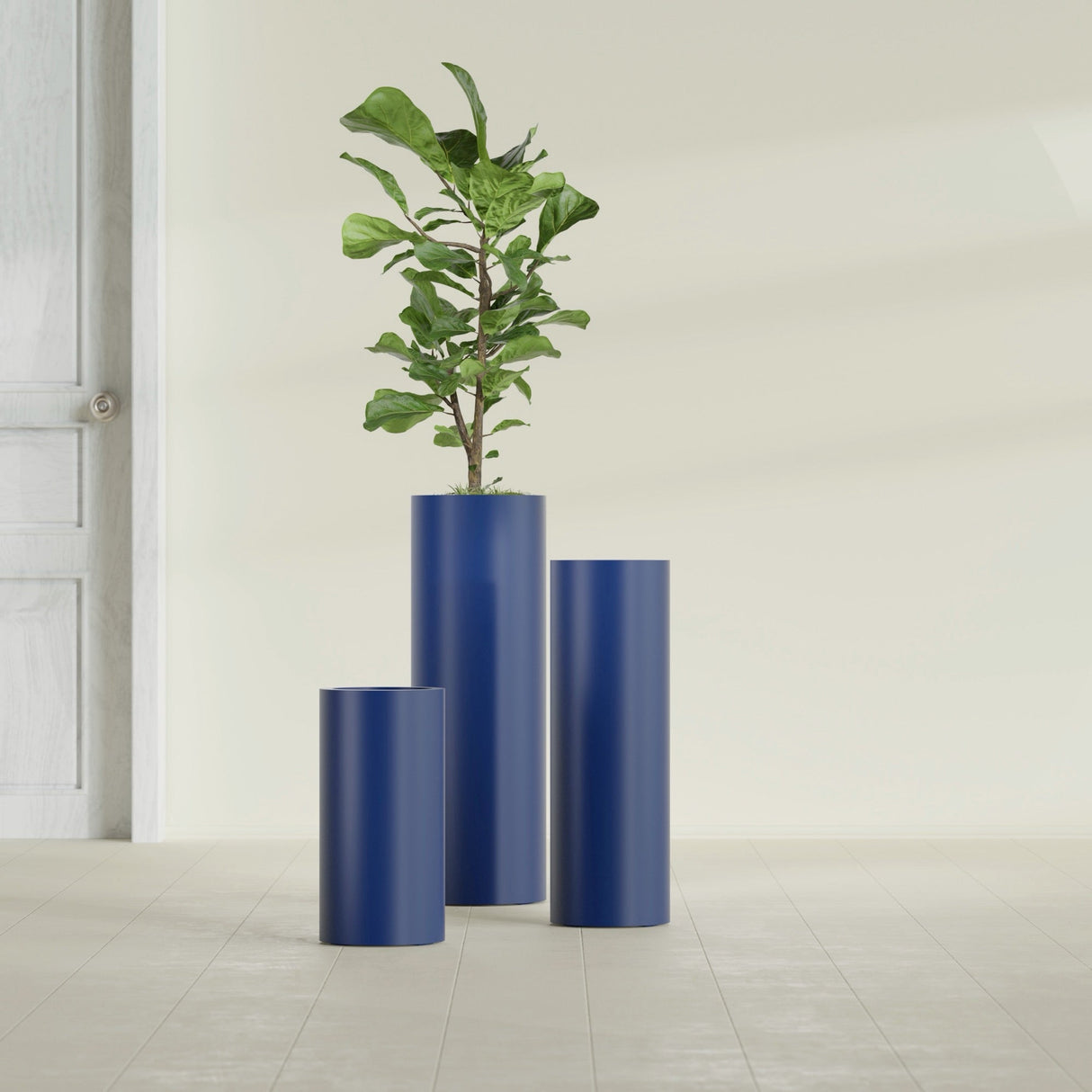 Corry Cylinder fiberglass planter in Matte Cobalt Blue, size range, in a sunlit interior