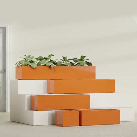 Cuba Corner fiberglass planter in Gloss Tangerine, size range, in a sunlit interior