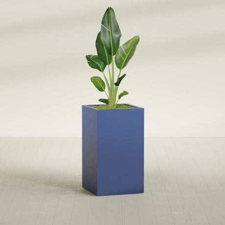 Darwin Corner fiberglass planter in Matte Cobalt Blue, shown planted, in a sunlit interior