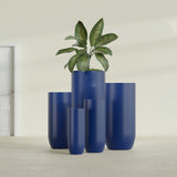 Saint Tropez Bullet Round fiberglass planter in Matte Cobalt Blue, size range, in a sunlit interior