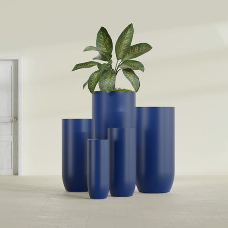 Saint Tropez Bullet Round fiberglass planter in Matte Cobalt Blue, size range, in a sunlit interior