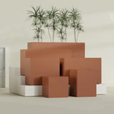 Brisbane Corner fiberglass planter in Matte Terra Cotta, size range, in a sunlit interior