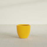 Wannsee Round Planter in Gloss Saffron, 27"D × 24"H, shown empty