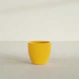 Wannsee Round Planter in Gloss Saffron, 27"D × 24"H, shown empty